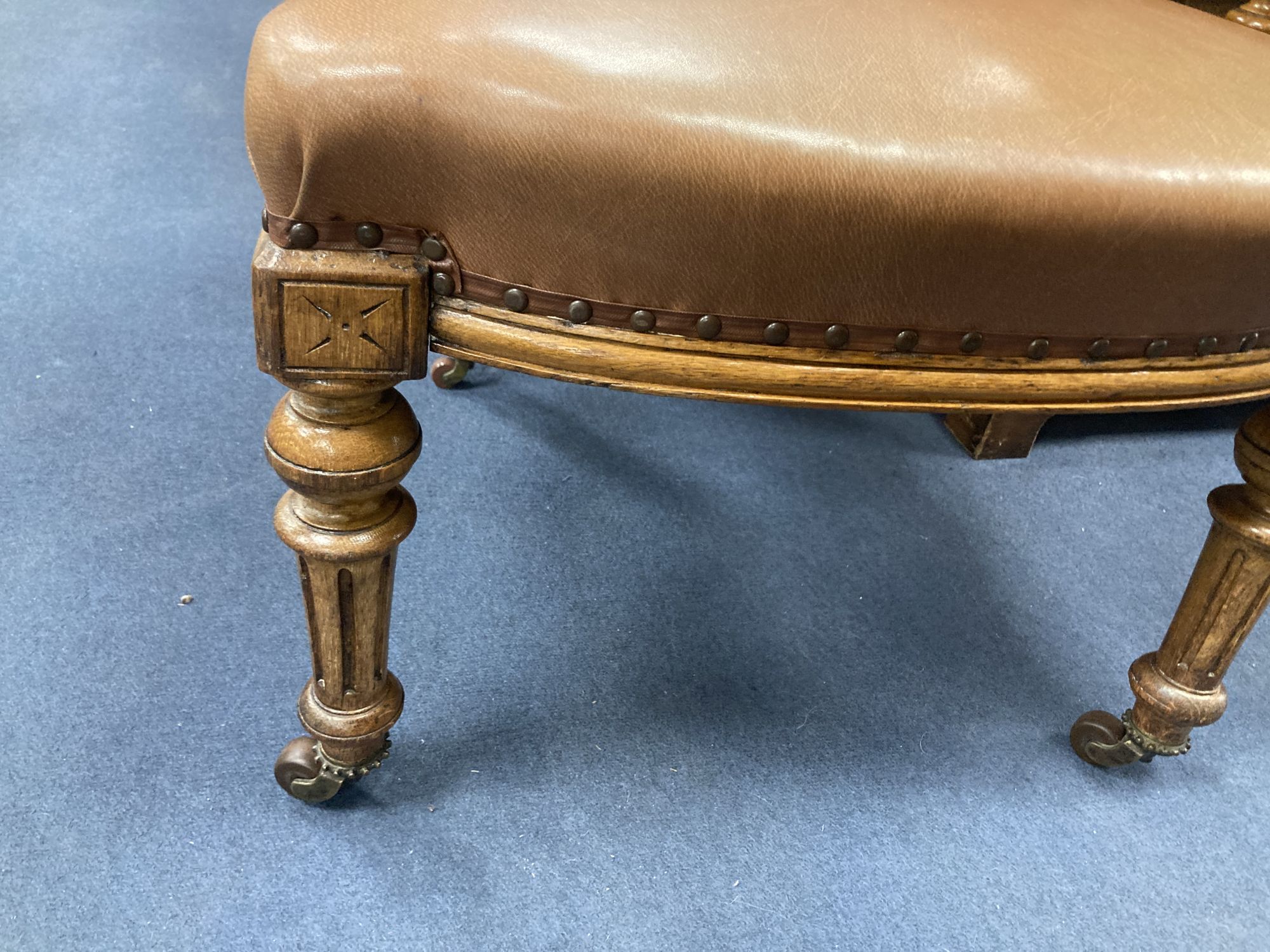 A Victorian oak tub framed library chair, upholstered in brown leather, width 60cm, depth 60cm, height 74cm